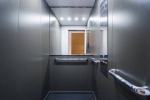 elevator Stainless steel elevator cabin interior with mirror. Modern passenger lift with convenient control panel in building. Transportation concept. Accessible environment for disabled people